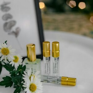 A stylish composition of perfume bottles with daisies and golden caps, perfect for beauty concepts.